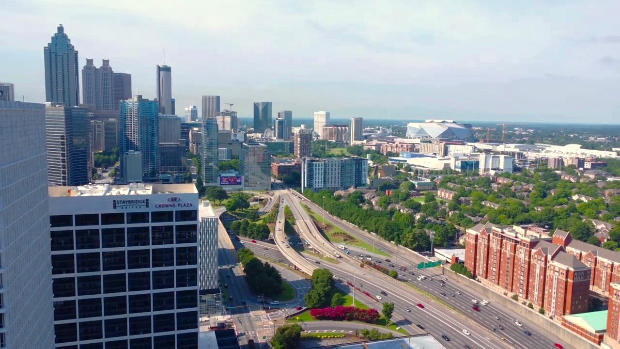 Downtown Atlanta skyline aerial &mdash; drone view of urban infrastructure, hotel towers, and interstate
