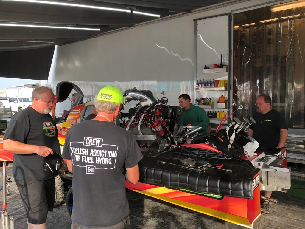 Pit crew working on a top-fuel hydro racing engine